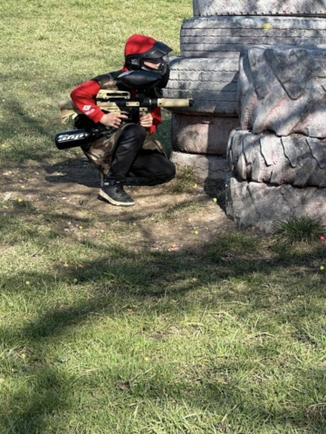 Paintball player in red equipment